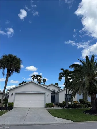 a front view of a house with a yard and a garage