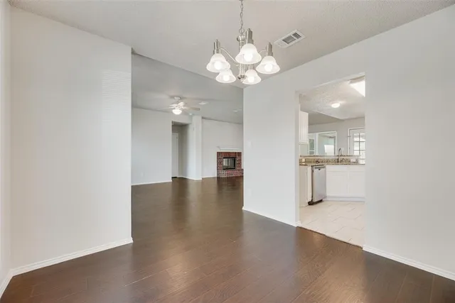 a view of a kitchen with a dishwasher cabinets and a large window