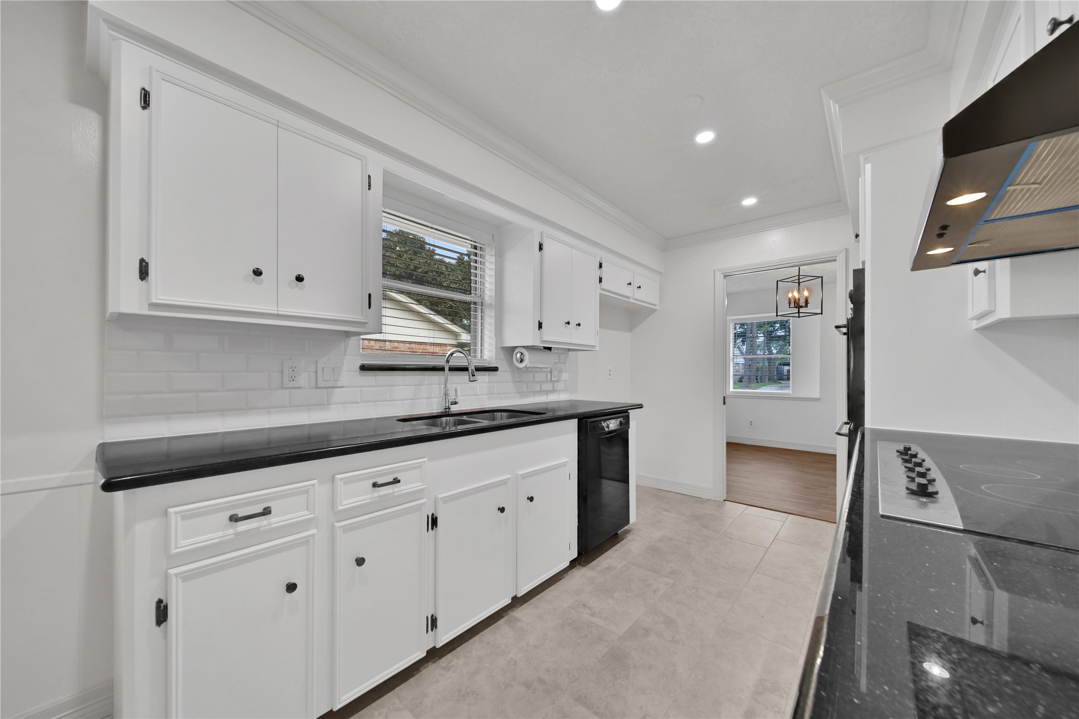 9411 Roos Road Houston, TX 77036 - Photo 17 of 41 a kitchen with granite countertop white cabinets and white appliances