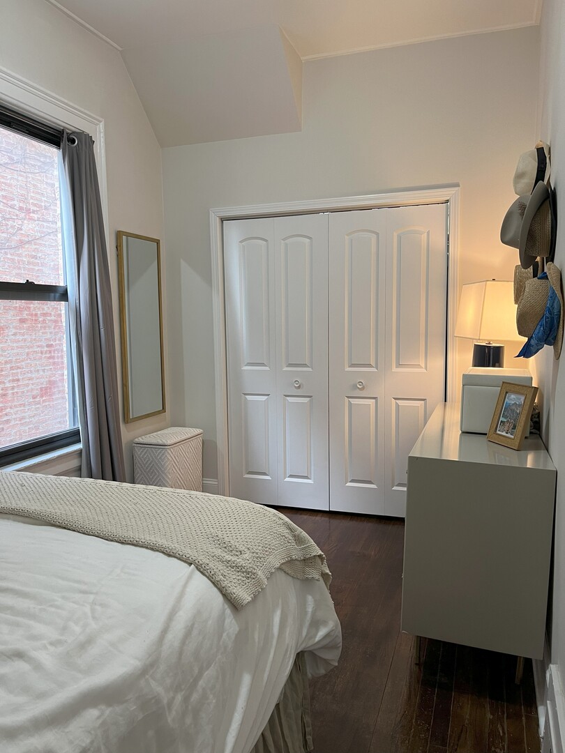 Undisclosed Address Chicago, IL 60622 - Photo 13 of 17 a bedroom with a bed and a chair with the wooden floor