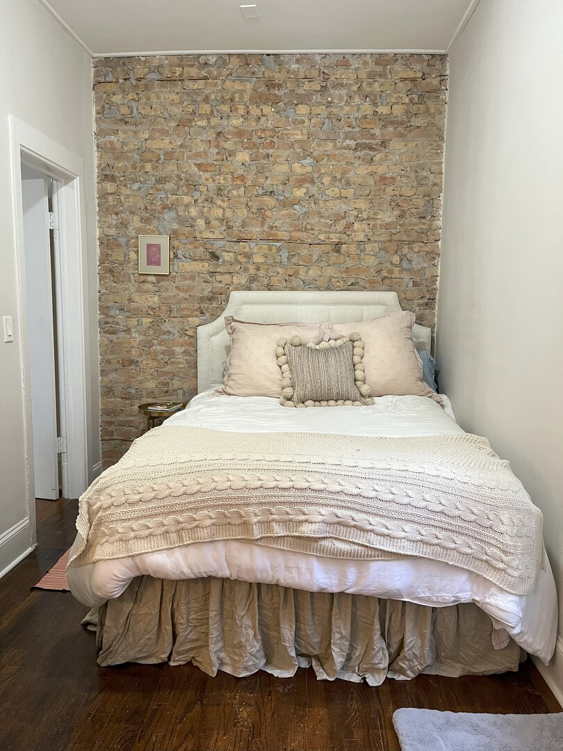 Undisclosed Address Chicago, IL 60622 - Photo 14 of 17 a bedroom with a bed and wooden floor