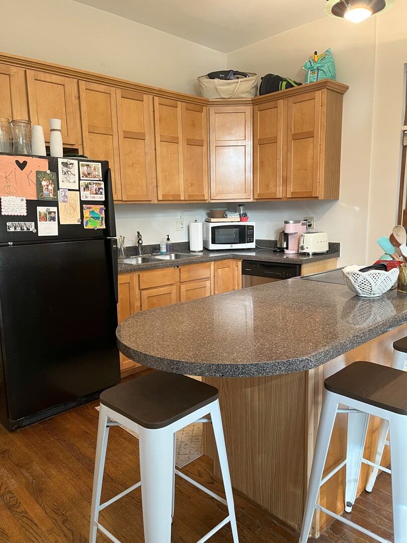Undisclosed Address Chicago, IL 60622 - Photo 10 of 17 a kitchen with stainless steel appliances granite countertop a stove a sink and a microwave