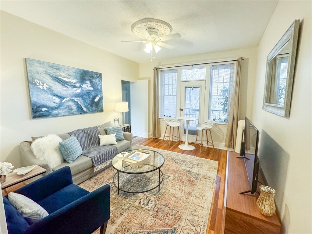 29 Mt Hood Road, Unit 12FURNISHED Boston, MA 02135 - Photo 3 of 11 a living room with furniture and a chandelier