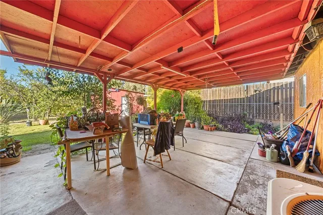 a view of a patio with table and chairs and potted plants