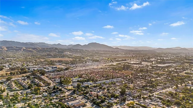 an aerial view of residential houses with outdoor space and mountain view