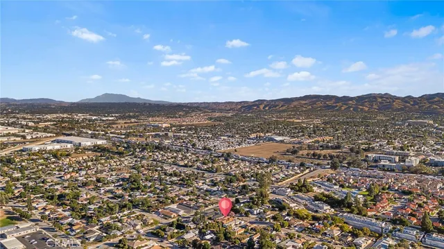 an aerial view of residential houses with outdoor space and trees