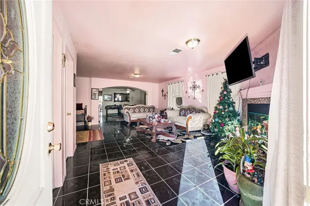 a living room with patio furniture and a flat screen tv