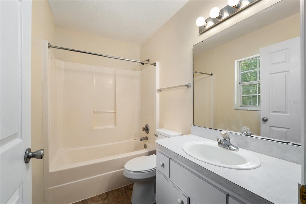 4329 Northwest 155th Street Reddick, FL 32686 - Photo 32 of 52 a bathroom with a sink a toilet and shower