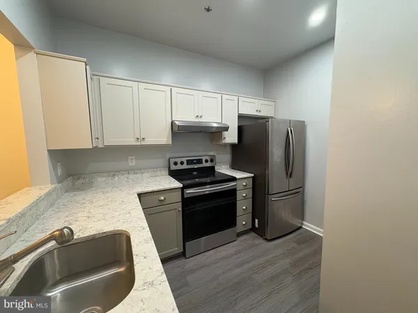 a kitchen with a refrigerator sink and stove