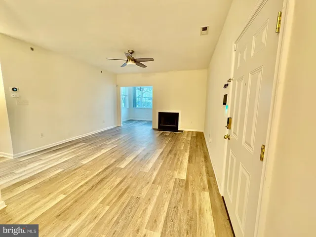 a view of a room with wooden floor and door