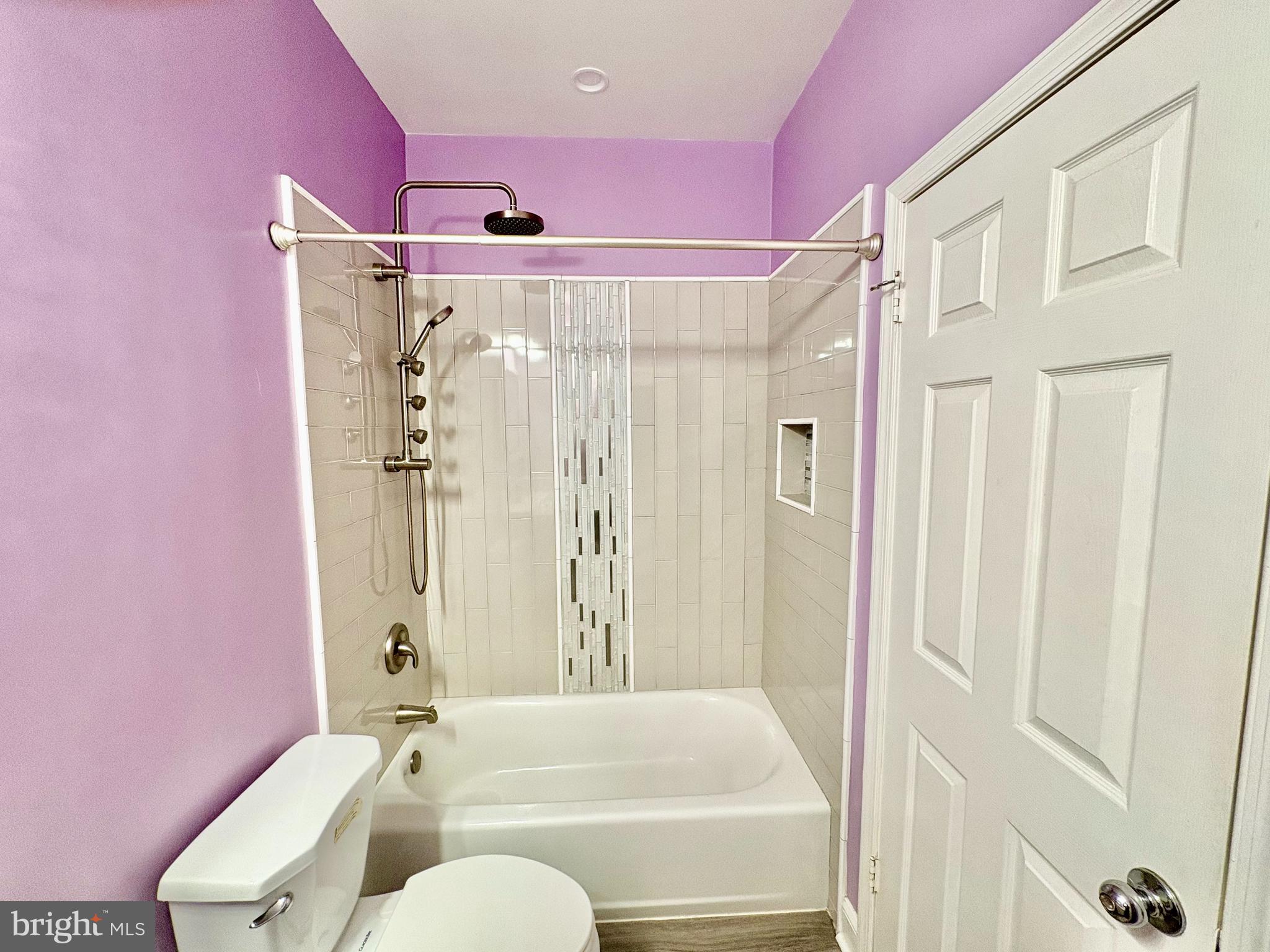 606 Moonglow Road, Unit 103 Odenton, MD 21113 - Photo 14 of 21 a bathroom with a shower curtain and a sink