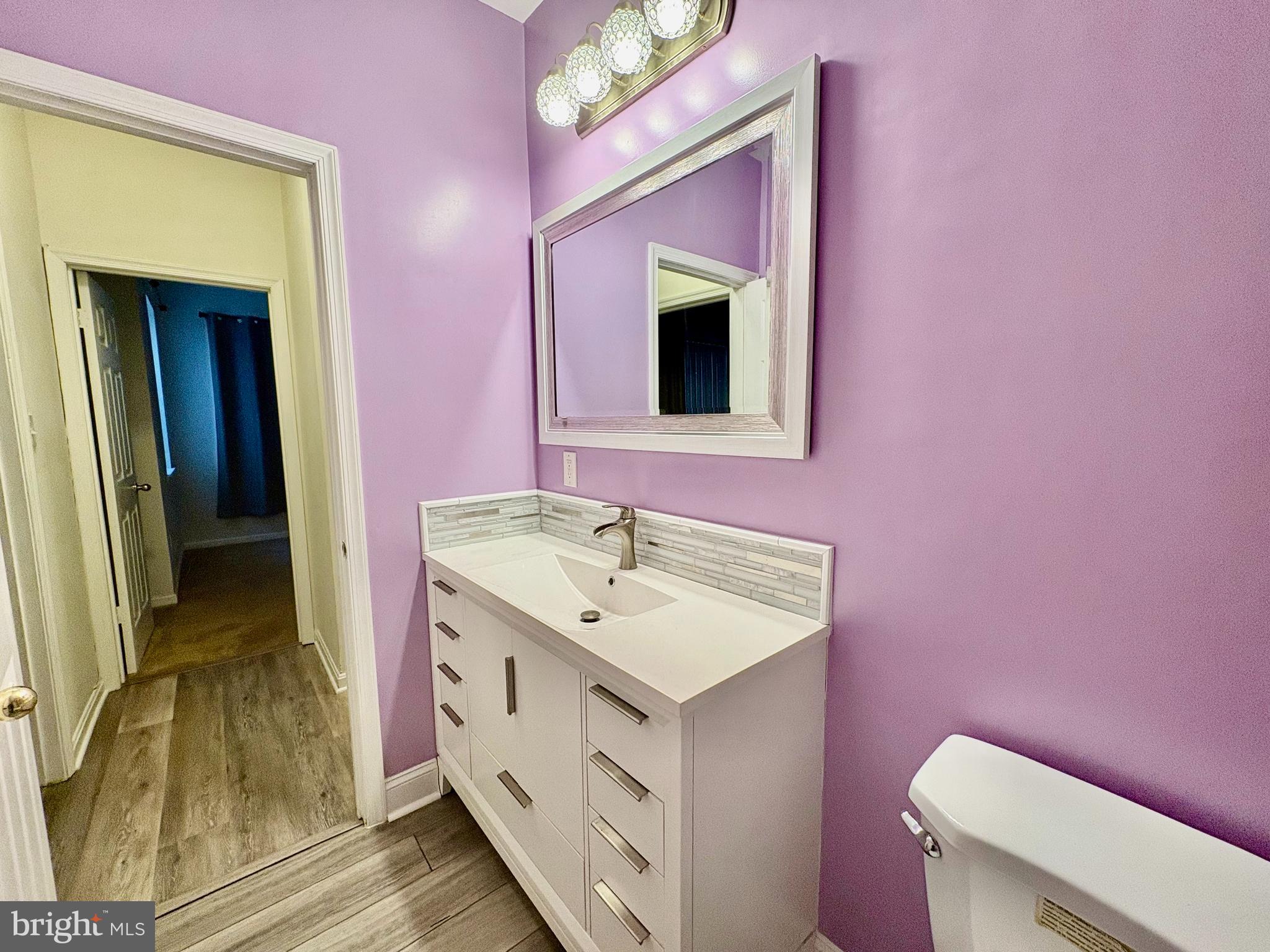 606 Moonglow Road, Unit 103 Odenton, MD 21113 - Photo 15 of 21 a bathroom with a sink a toilet and mirror