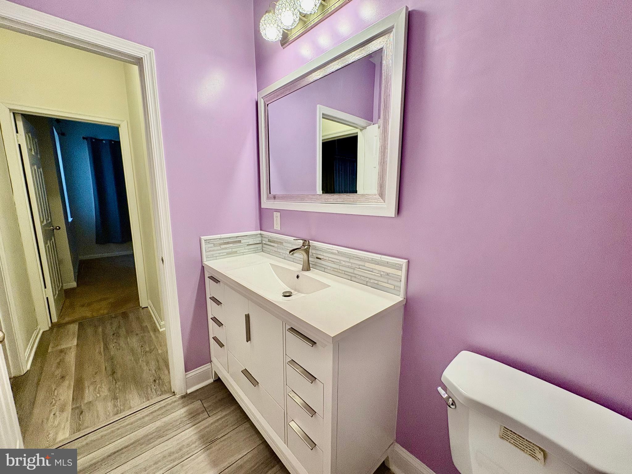 606 Moonglow Road, Unit 103 Odenton, MD 21113 - Photo 17 of 21 a bathroom with a toilet sink and mirror