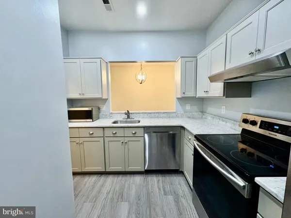 a kitchen with appliances cabinets and a window