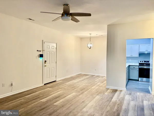 a view of a kitchen with a sink and a refrigerator