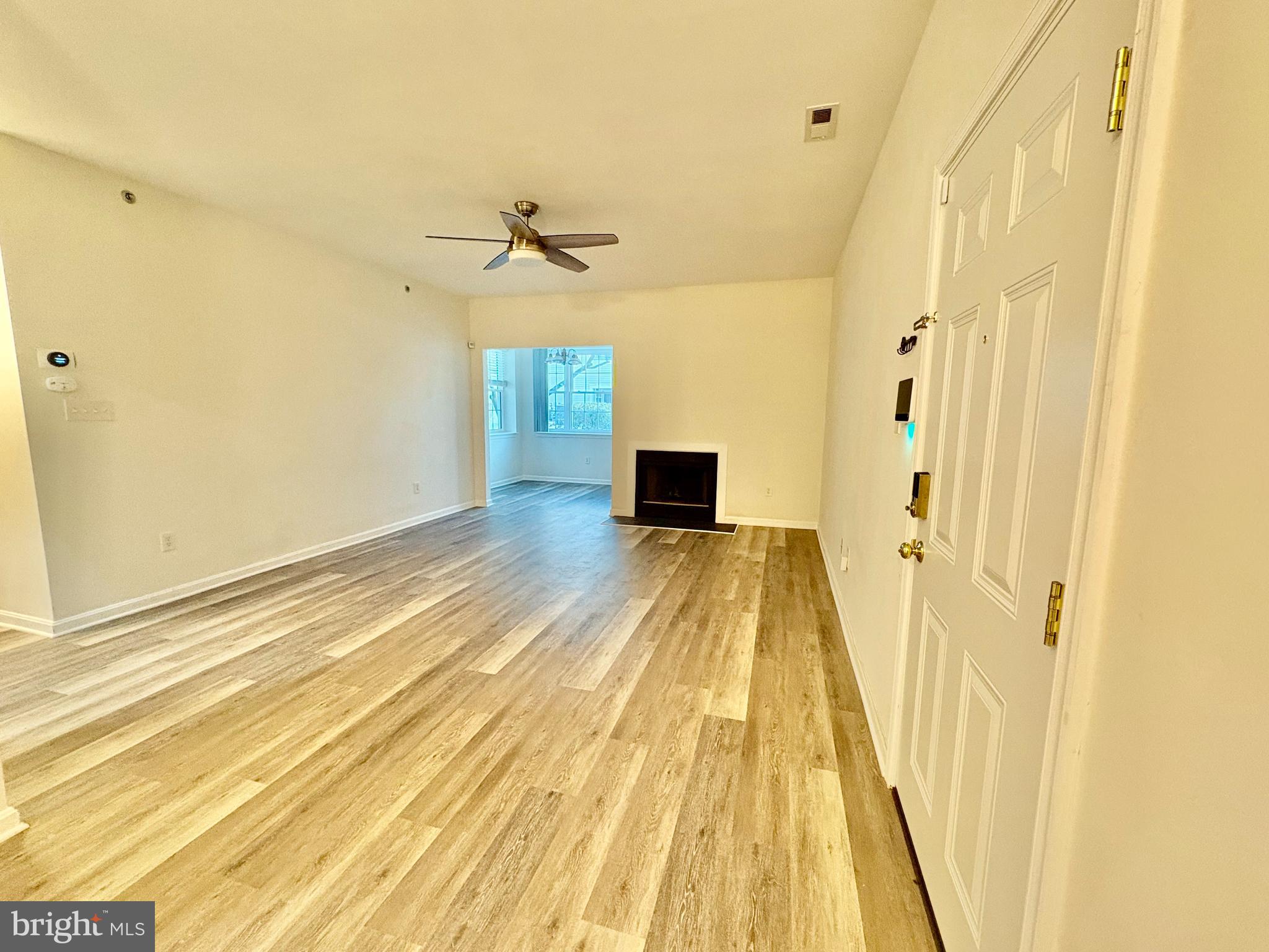 606 Moonglow Road, Unit 103 Odenton, MD 21113 - Photo 5 of 21 a view of a room with wooden floor and door