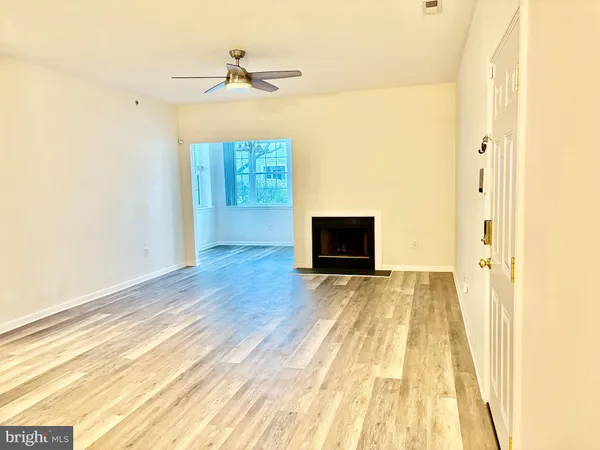 a view of a livingroom with wooden floor and a flat screen tv