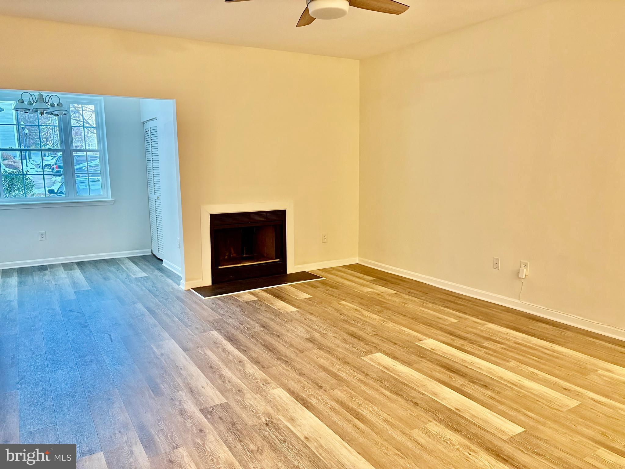 606 Moonglow Road, Unit 103 Odenton, MD 21113 - Photo 9 of 21 a view of empty room with wooden floor and fan