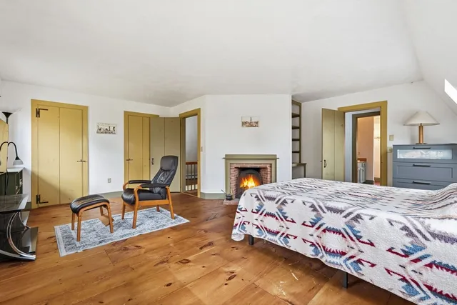 a bedroom with a bed and a fireplace