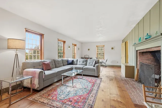 a living room with furniture wooden floor and a fireplace
