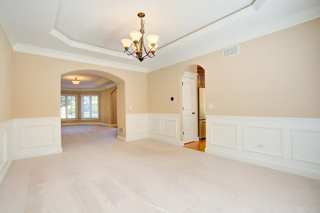 a view of a chandelier fan and entryway