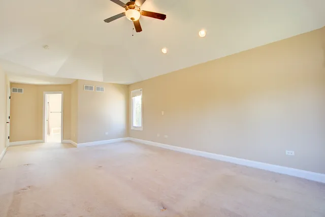 a view of a livingroom with a ceiling fan and window