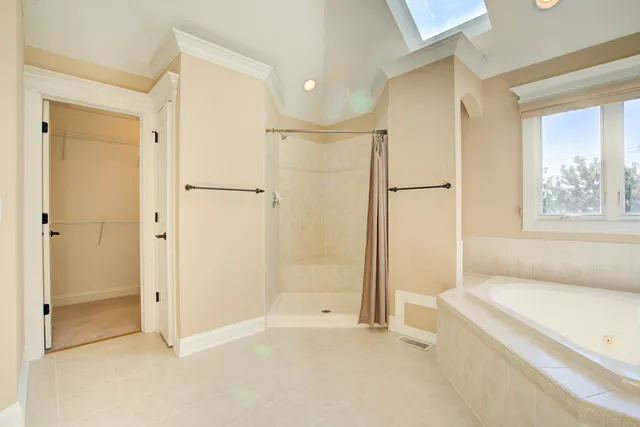 a bathroom with a tub and a shower