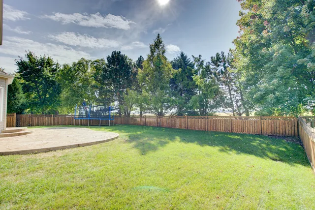 a view of a backyard with swimming pool