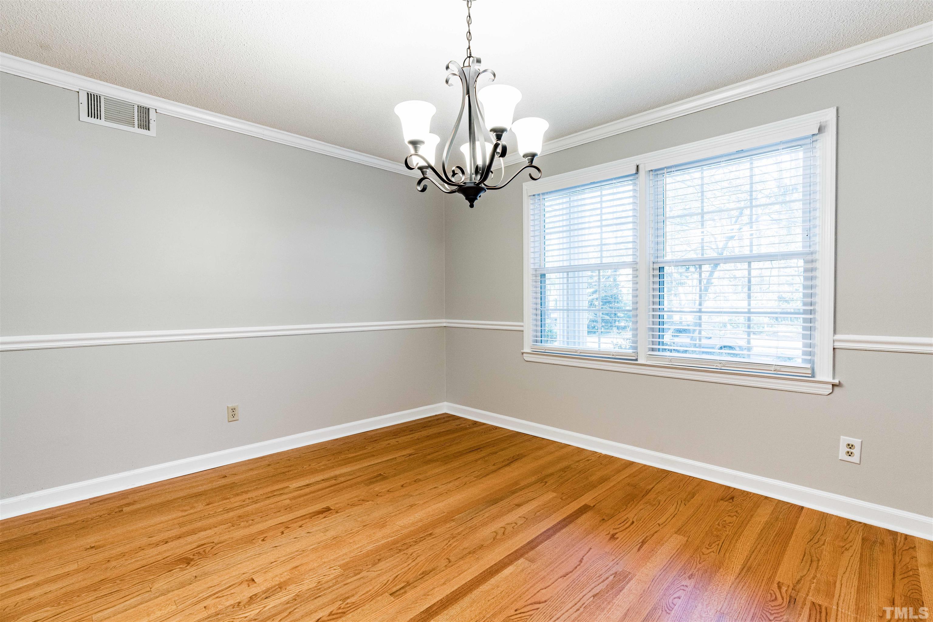 103 Marilyn Circle Cary, NC 27513 - Photo 17 of 64 a view of a room with wooden floor and chandelier