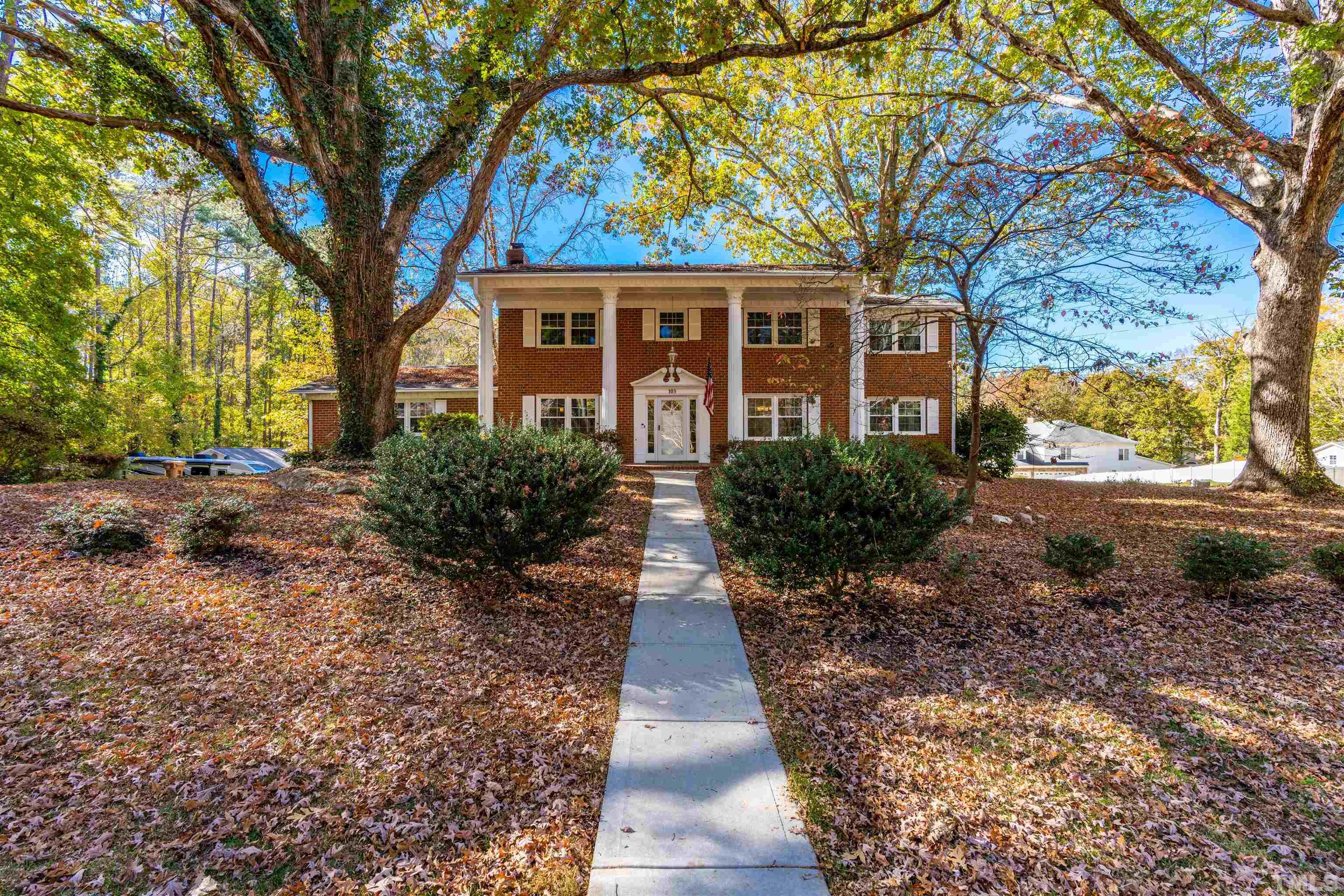103 Marilyn Circle Cary, NC 27513 - Photo 2 of 64 a front view of a house with a yard and shrubs