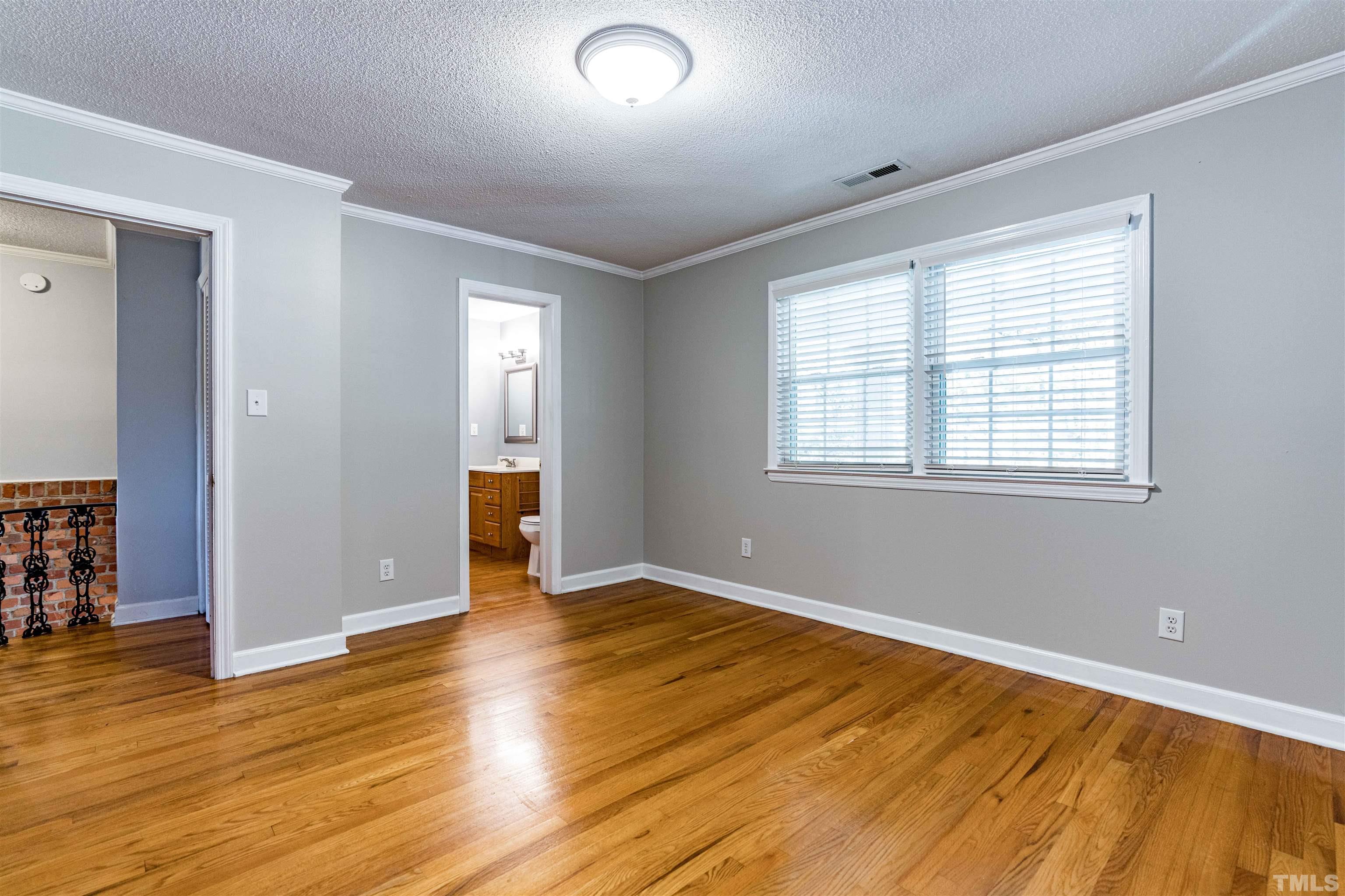 103 Marilyn Circle Cary, NC 27513 - Photo 24 of 64 an empty room with wooden floor and windows