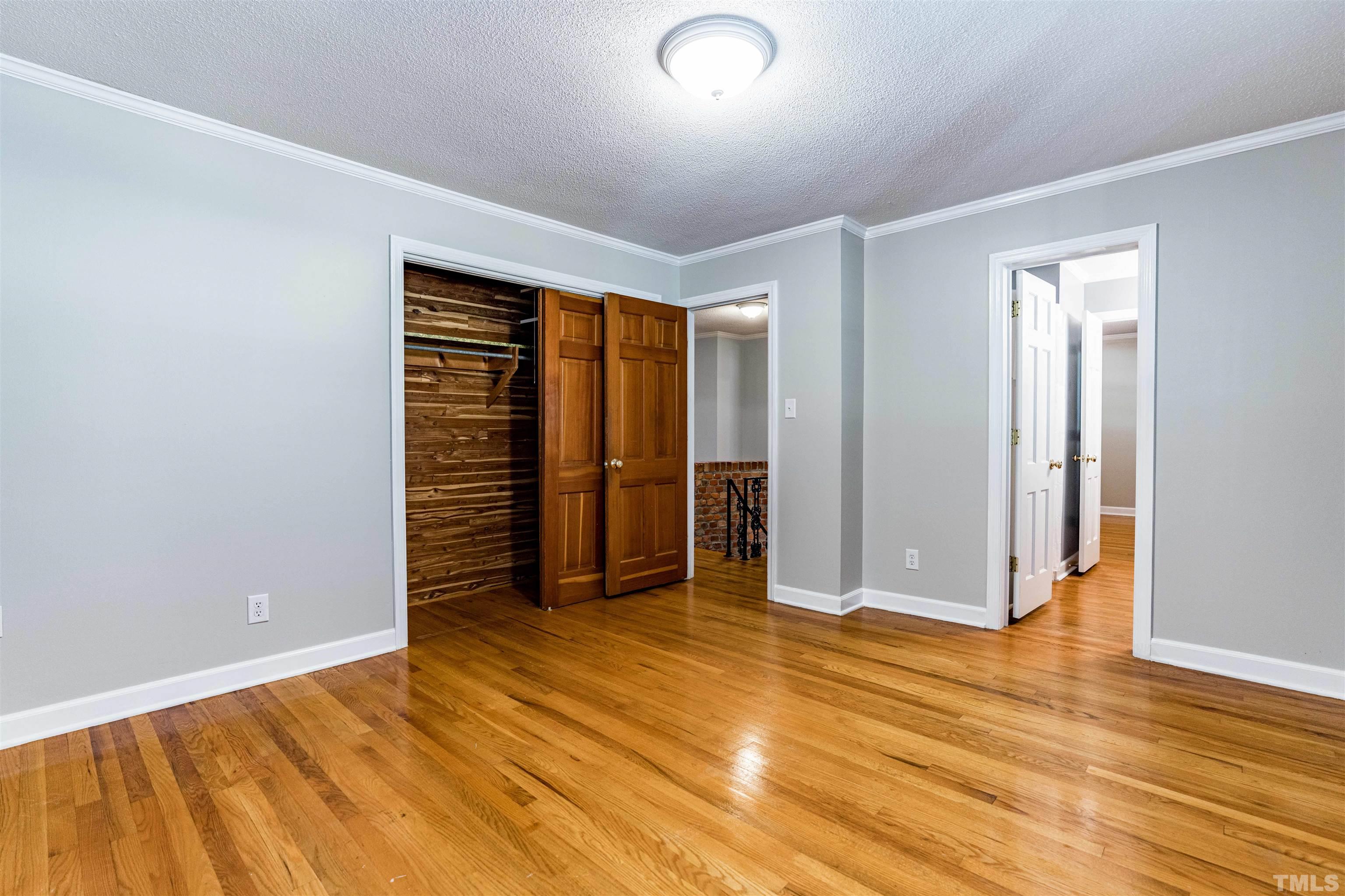 103 Marilyn Circle Cary, NC 27513 - Photo 25 of 64 an empty room with wooden floor and closet