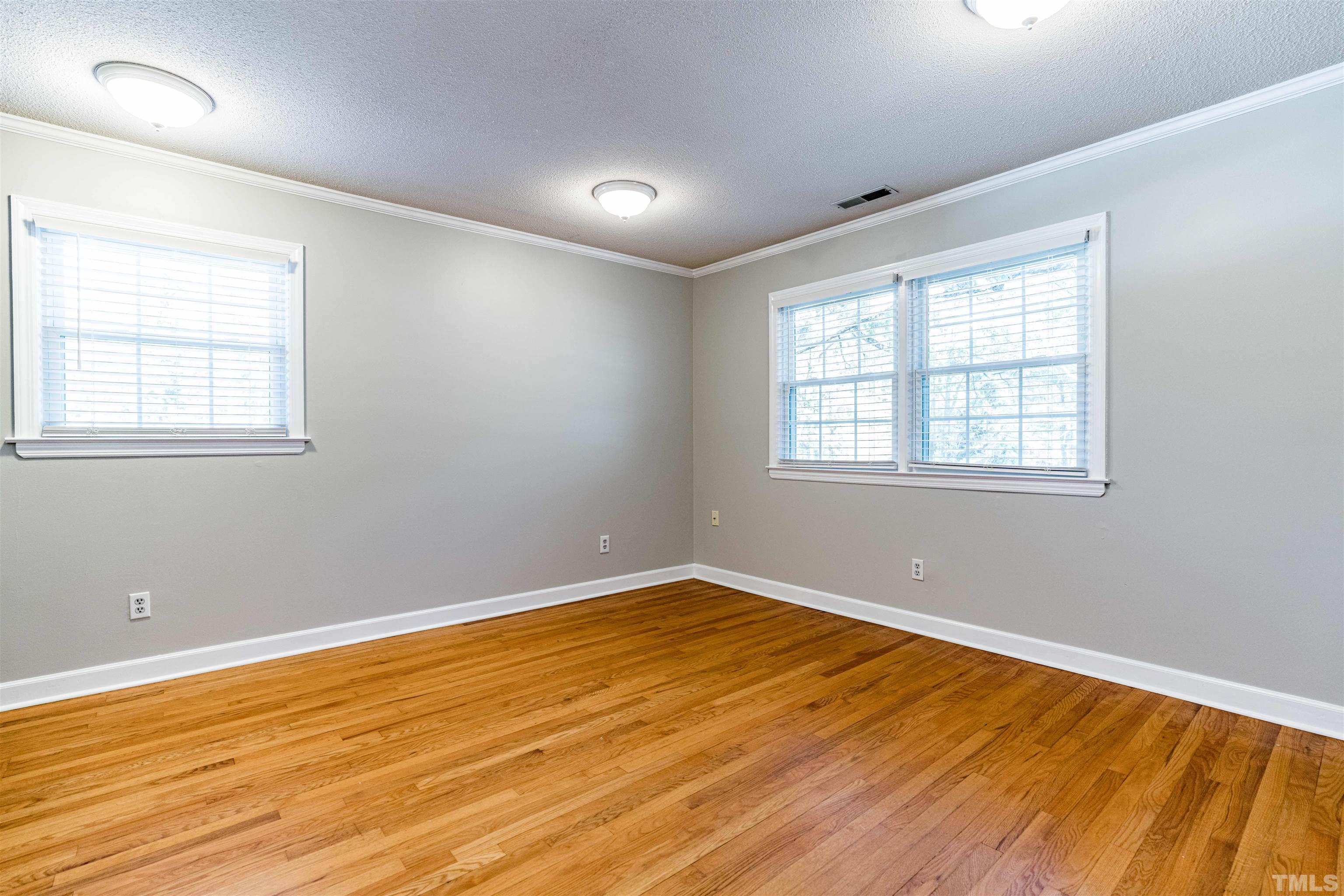 103 Marilyn Circle Cary, NC 27513 - Photo 29 of 64 an empty room with wooden floor and windows