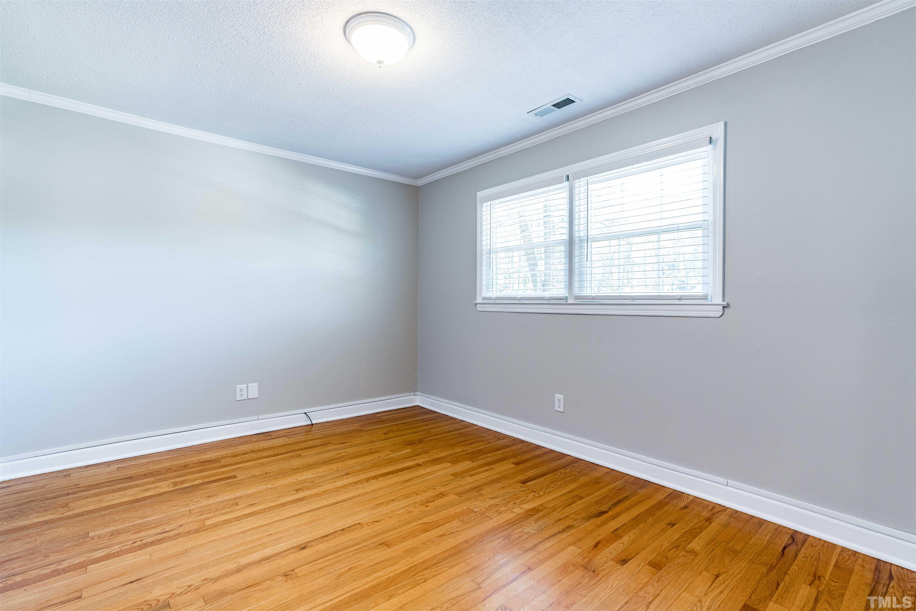 103 Marilyn Circle Cary, NC 27513 - Photo 30 of 64 an empty room with wooden floor and windows