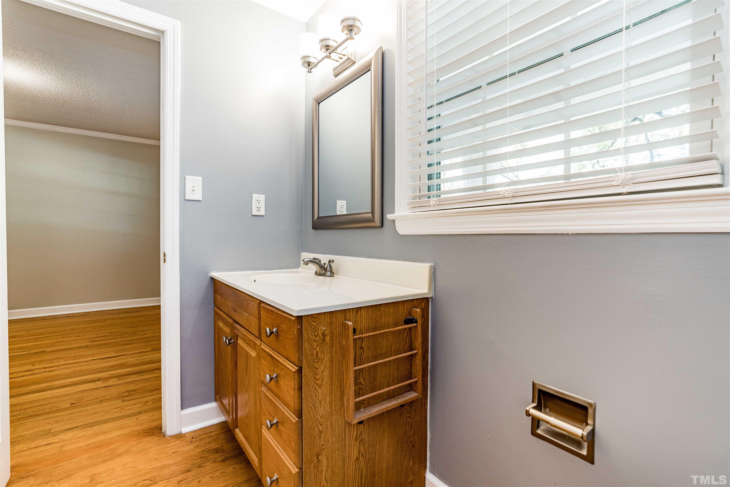 103 Marilyn Circle Cary, NC 27513 - Photo 35 of 64 a bathroom with a sink and a mirror