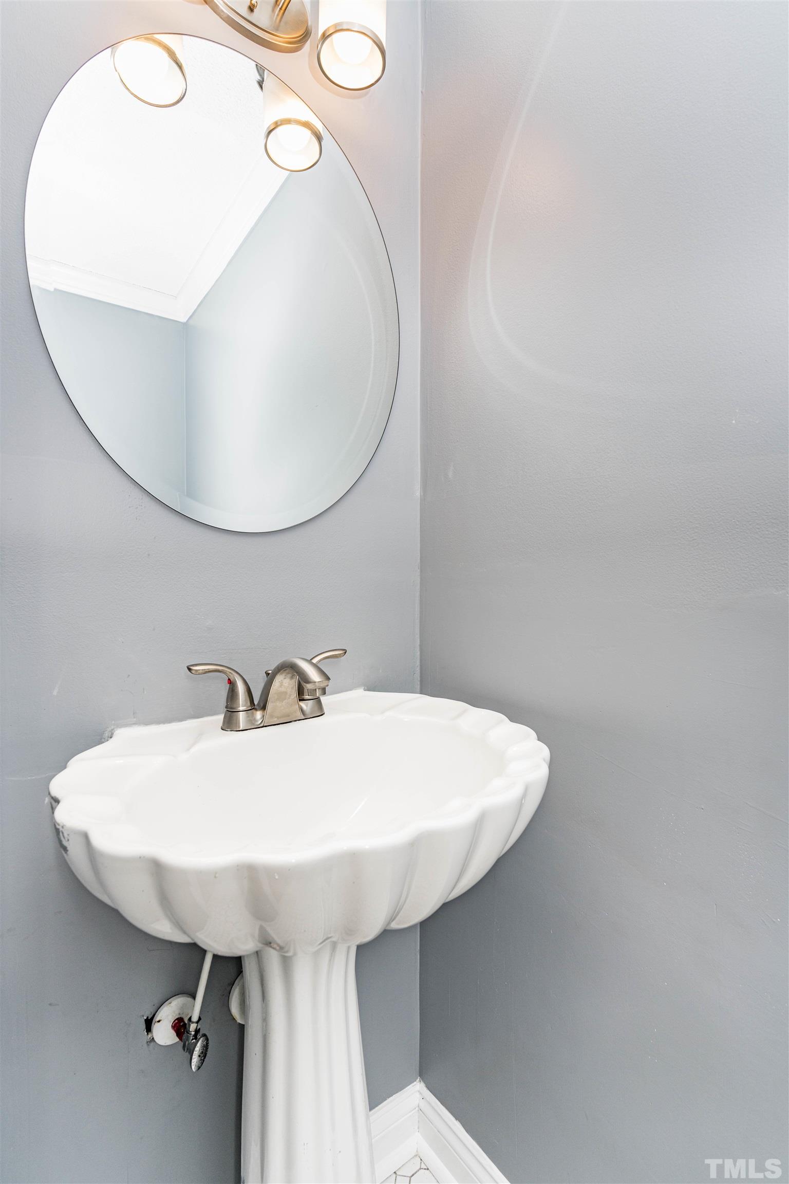 103 Marilyn Circle Cary, NC 27513 - Photo 37 of 64 a bathroom with a sink and mirror