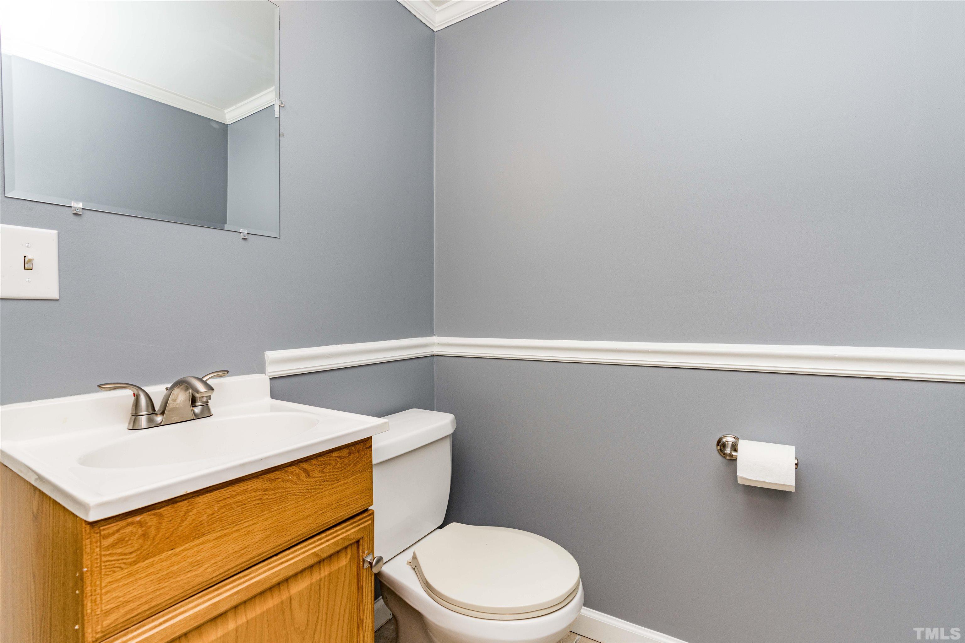103 Marilyn Circle Cary, NC 27513 - Photo 39 of 64 a white toilet sitting next to a bathroom sink