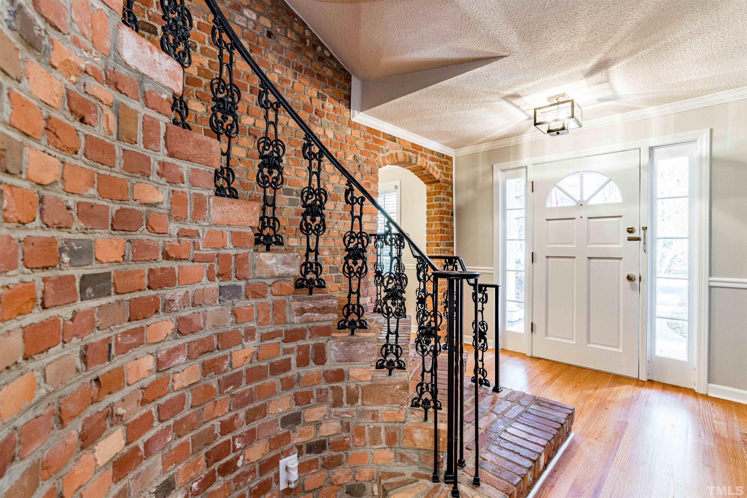 103 Marilyn Circle Cary, NC 27513 - Photo 4 of 64 a view of a hallway with wooden floor and staircase