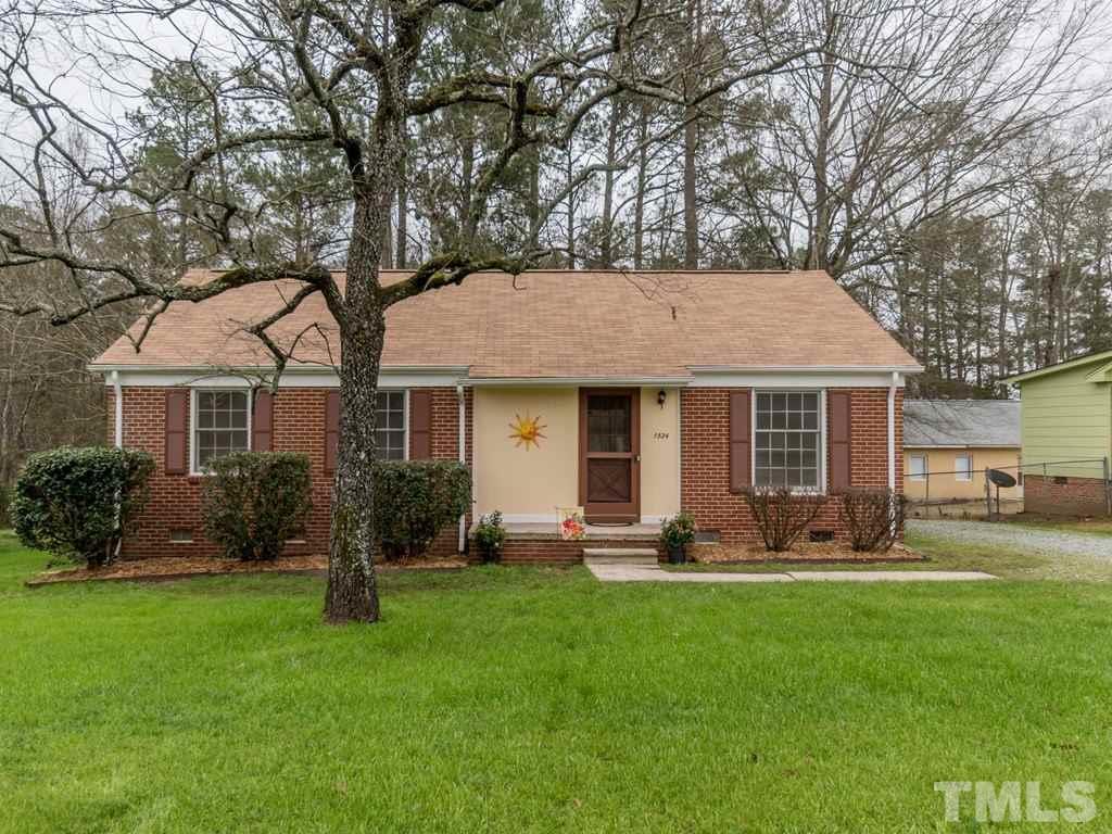 1524 Clermont Road Durham, NC 27713 - Photo 2 of 24 a front view of a house with a yard and trees