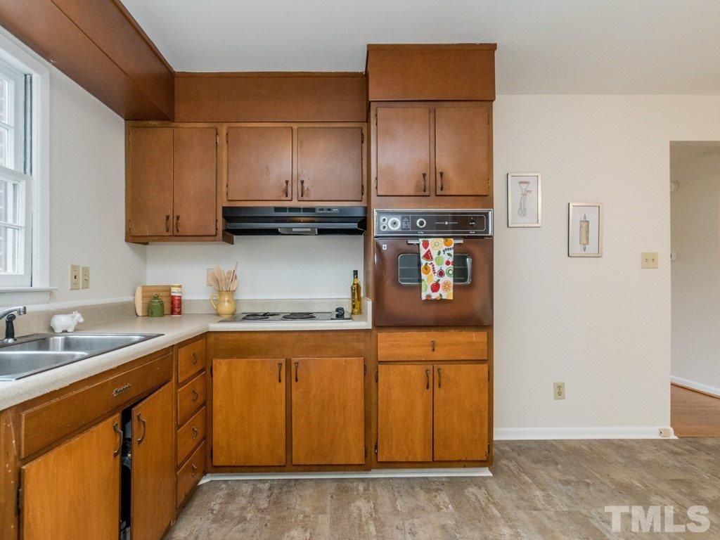 1524 Clermont Road Durham, NC 27713 - Photo 11 of 24 a kitchen with stainless steel appliances granite countertop a sink stove and cabinets