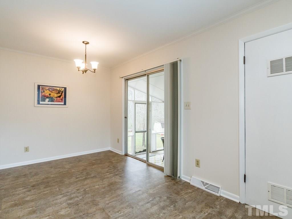 1524 Clermont Road Durham, NC 27713 - Photo 12 of 24 a view of a livingroom with a chandelier fan