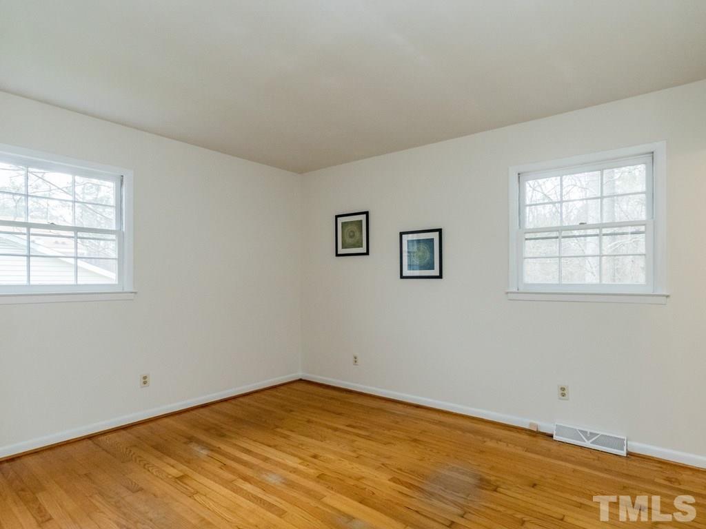1524 Clermont Road Durham, NC 27713 - Photo 14 of 24 an empty room with wooden floor and windows
