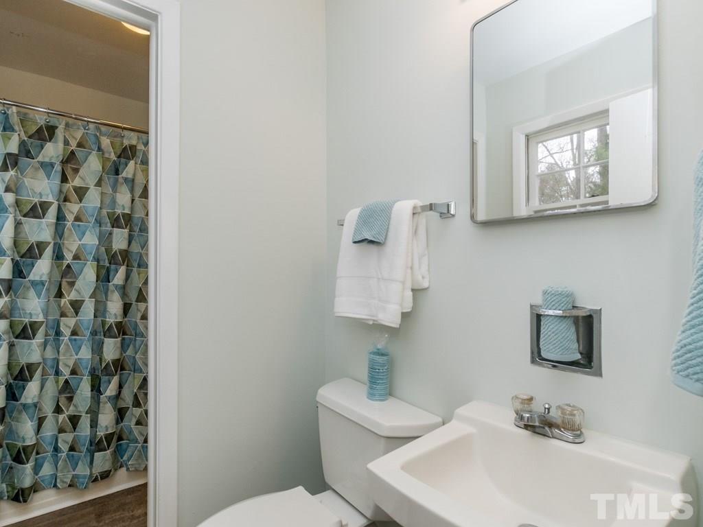 1524 Clermont Road Durham, NC 27713 - Photo 15 of 24 a bathroom with a sink toilet and mirror