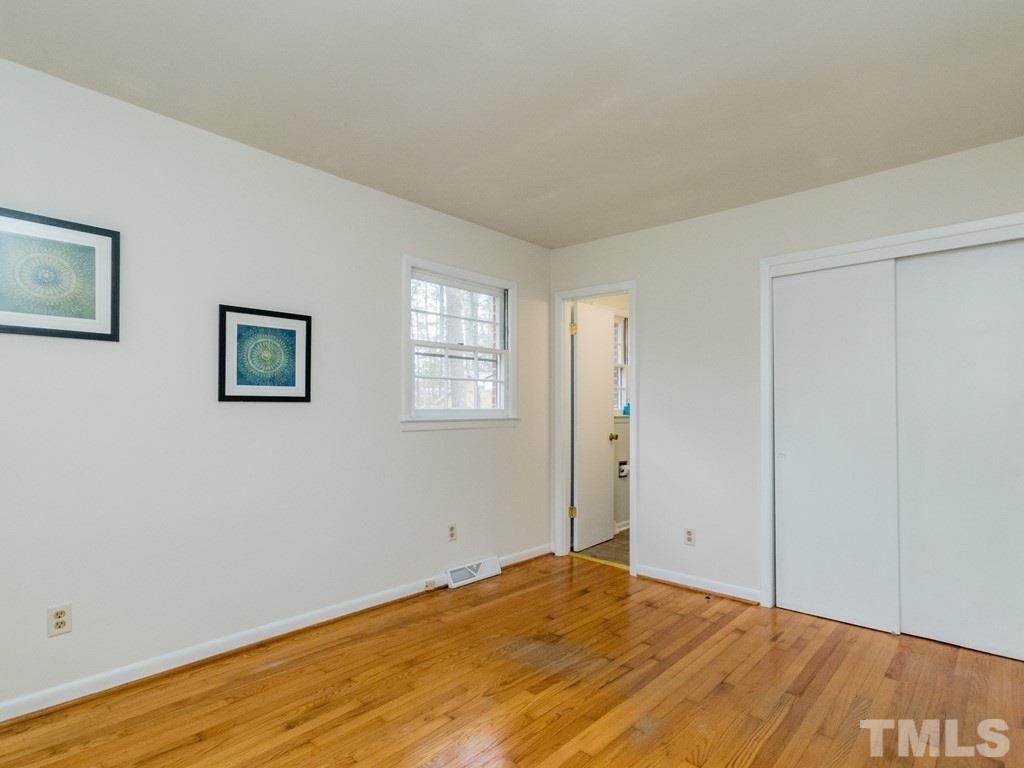 1524 Clermont Road Durham, NC 27713 - Photo 16 of 24 a view of a room with wooden floor and closet