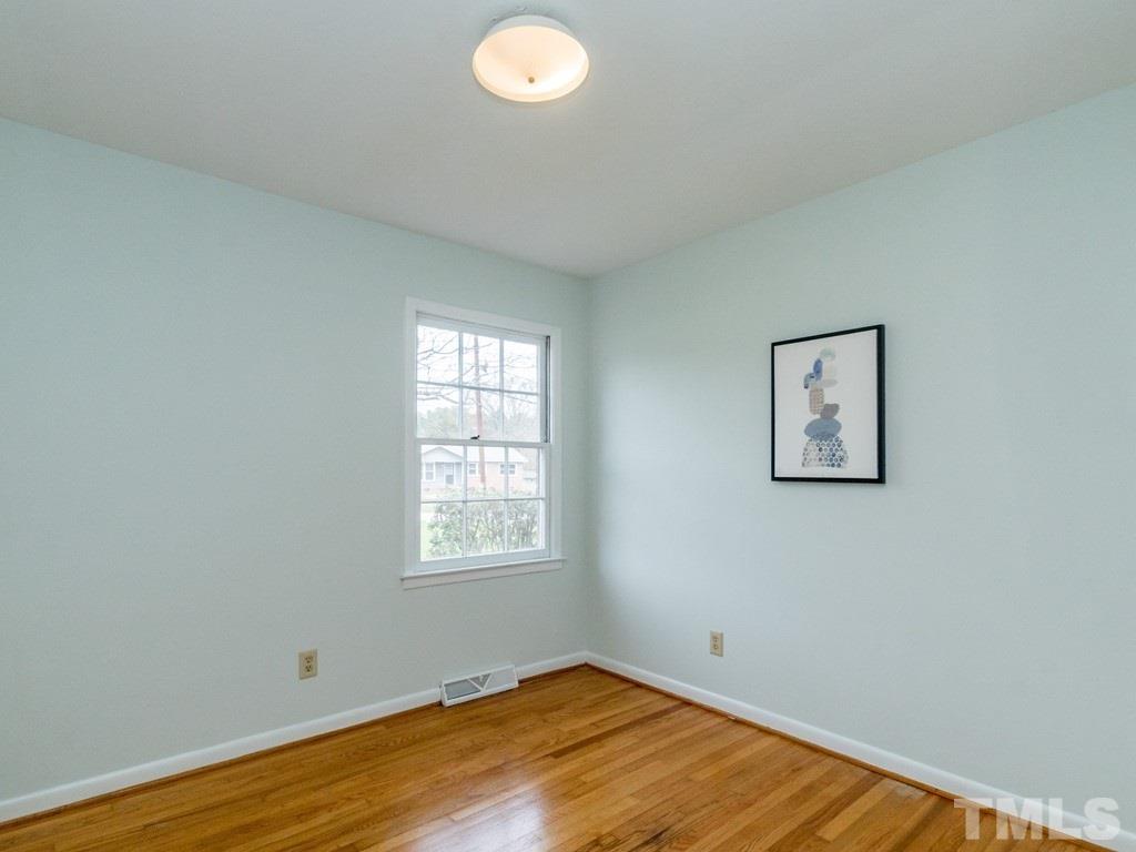 1524 Clermont Road Durham, NC 27713 - Photo 17 of 24 an empty room with wooden floor and windows