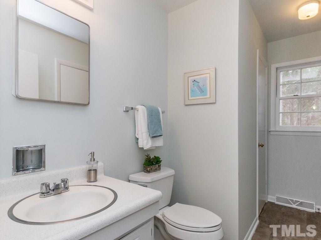 1524 Clermont Road Durham, NC 27713 - Photo 19 of 24 a bathroom with a sink toilet and a mirror