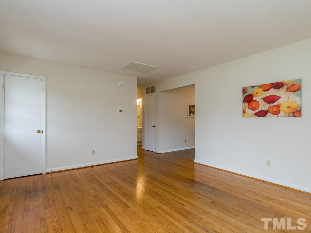1524 Clermont Road Durham, NC 27713 - Photo 4 of 24 a view of an empty room with wooden floor