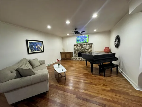 a living room with furniture and a wooden floor