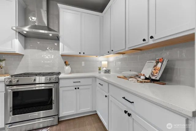 a kitchen with cabinets appliances and a sink