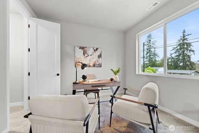 a dining room with furniture and a potted plant